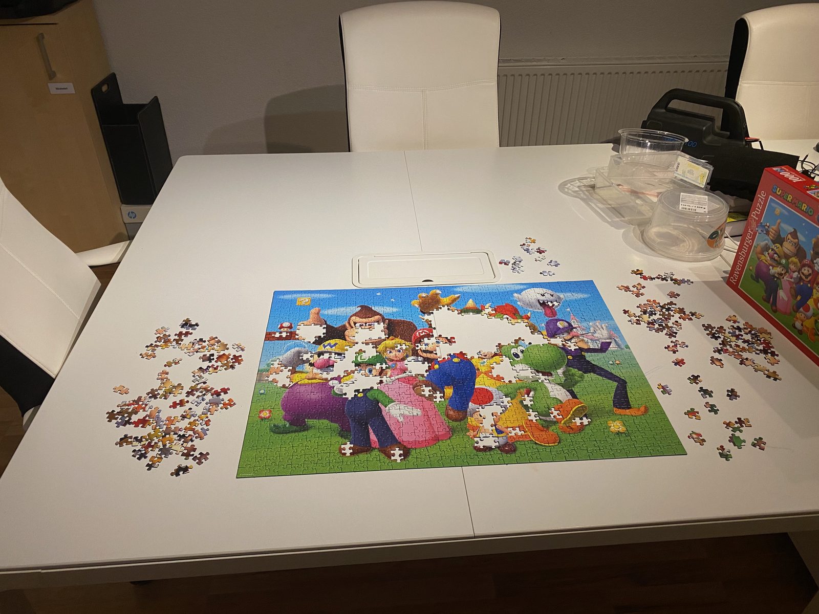 A large jigsaw puzzle laid out on a table during family puzzle night.