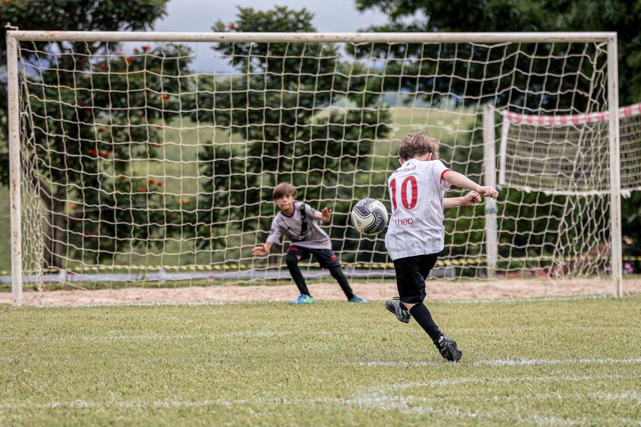 A young footballer taking a penalty kick at a penalty-shootout tournament.